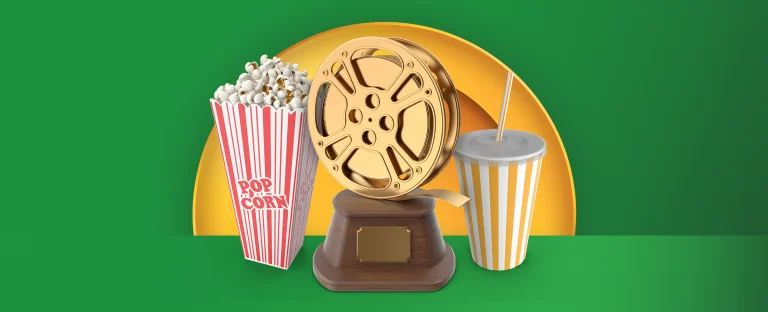 A popcorn bucket, a golden film reel trophy, and a striped soda cup are arranged in front of a golden half circle on a green background.